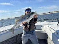 A lone angler fishing in the waters of Belmar