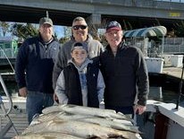 Four people enjoying a fishing trip in NJ