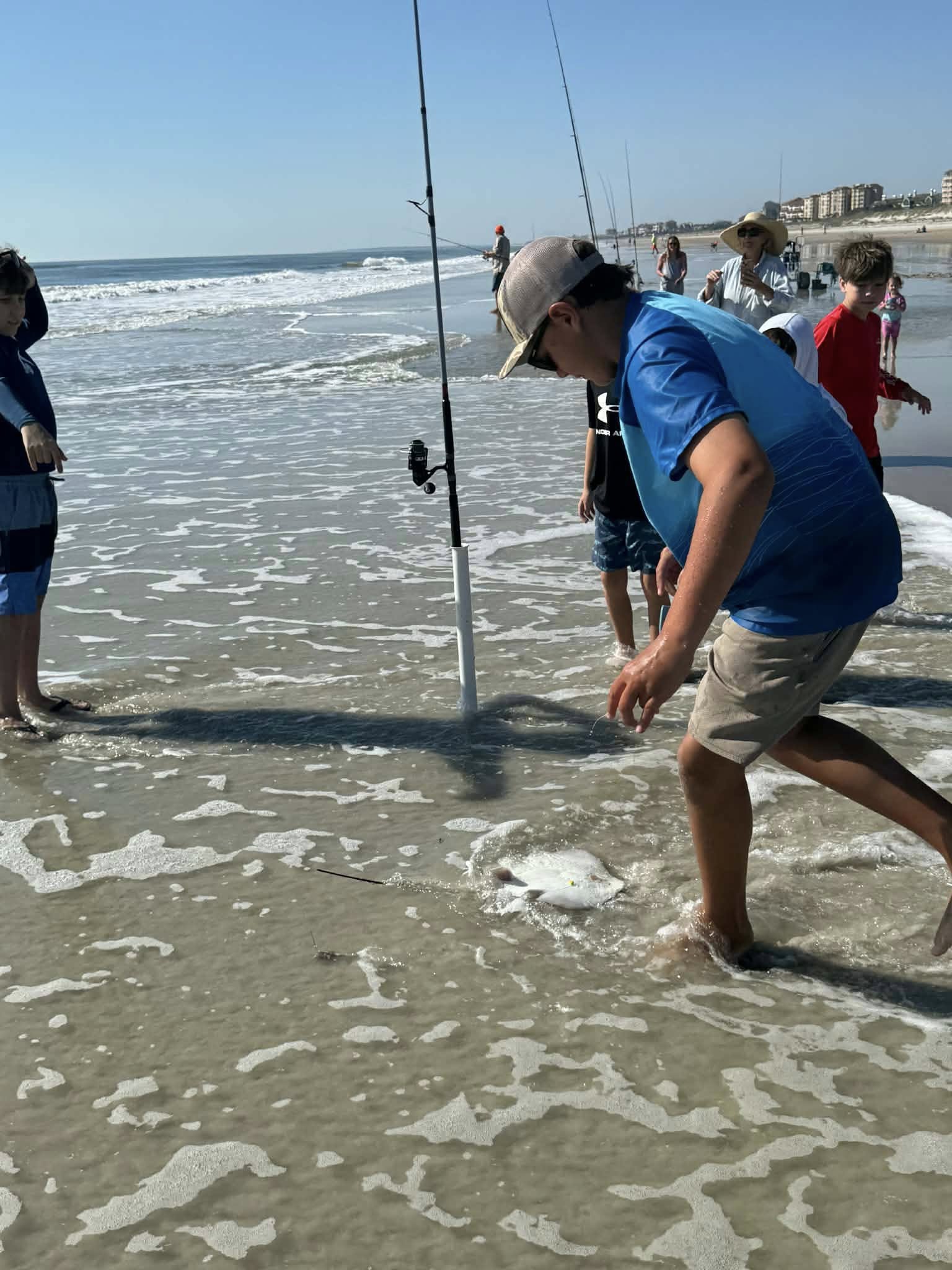 Surf fishing scene at Fernandina Beach FL with fishing rods and catch in shallow water