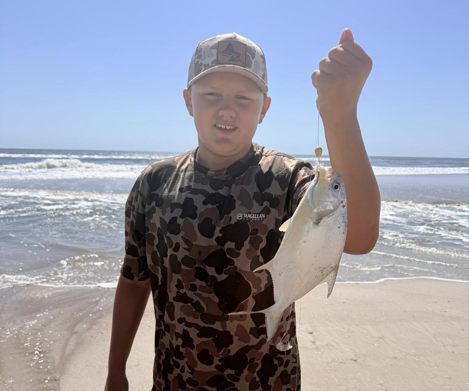 Captain Brandon Biddle surf fishing from Fernandina Beach shore with rod and reel on Amelia Island
