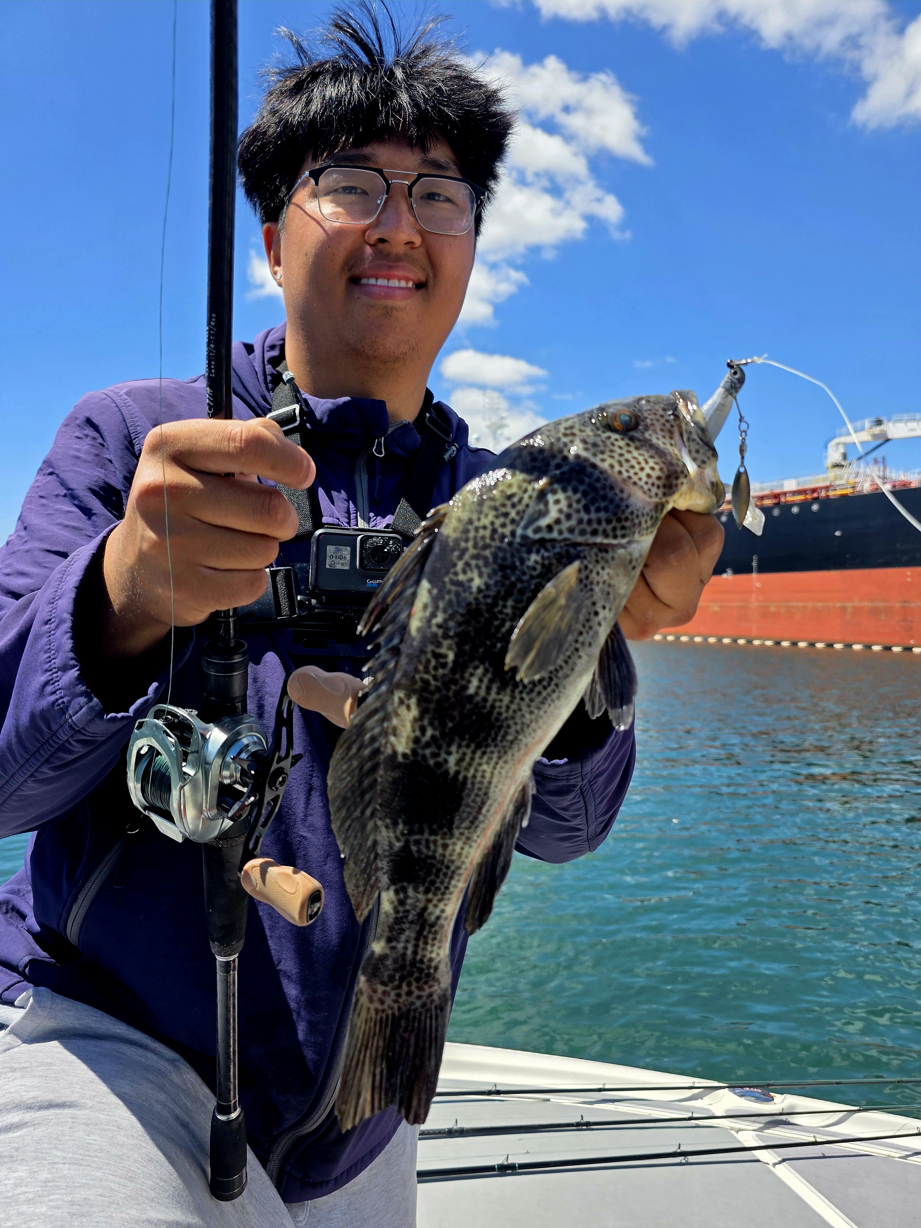 Angler holding caught fish on fishing boat in Garden Grove CA waters