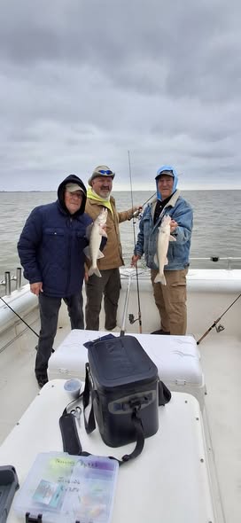Fishing trip on boat in Port Clinton OH with fishing rods and tackle box on deck