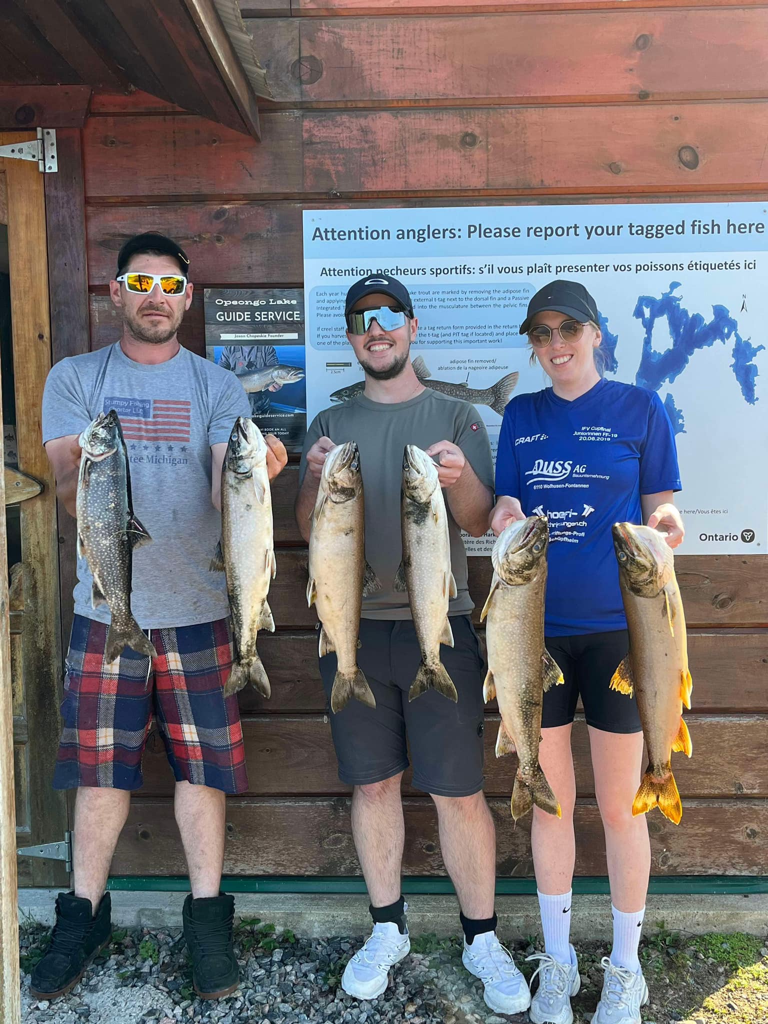 Anglers with six large lake trout and silver carp in ON