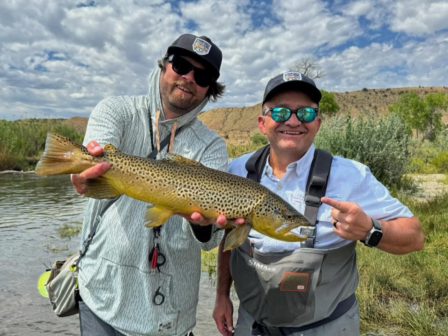 Guide and anglers fishing for trout on river waters during 4-hour guided fishing trip