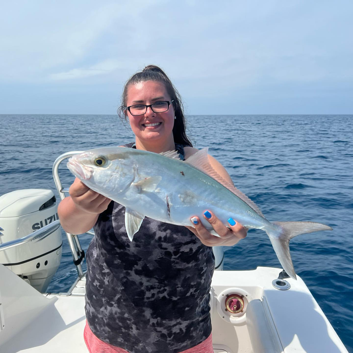 Angler catches a blue runner fish in Tierra Verde