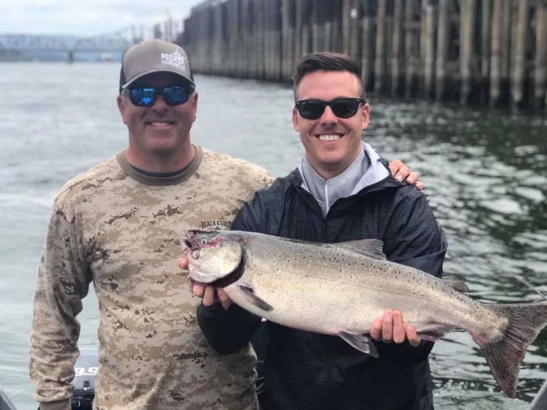 Angler posing with a large rainbow trout fish caught in Portland
