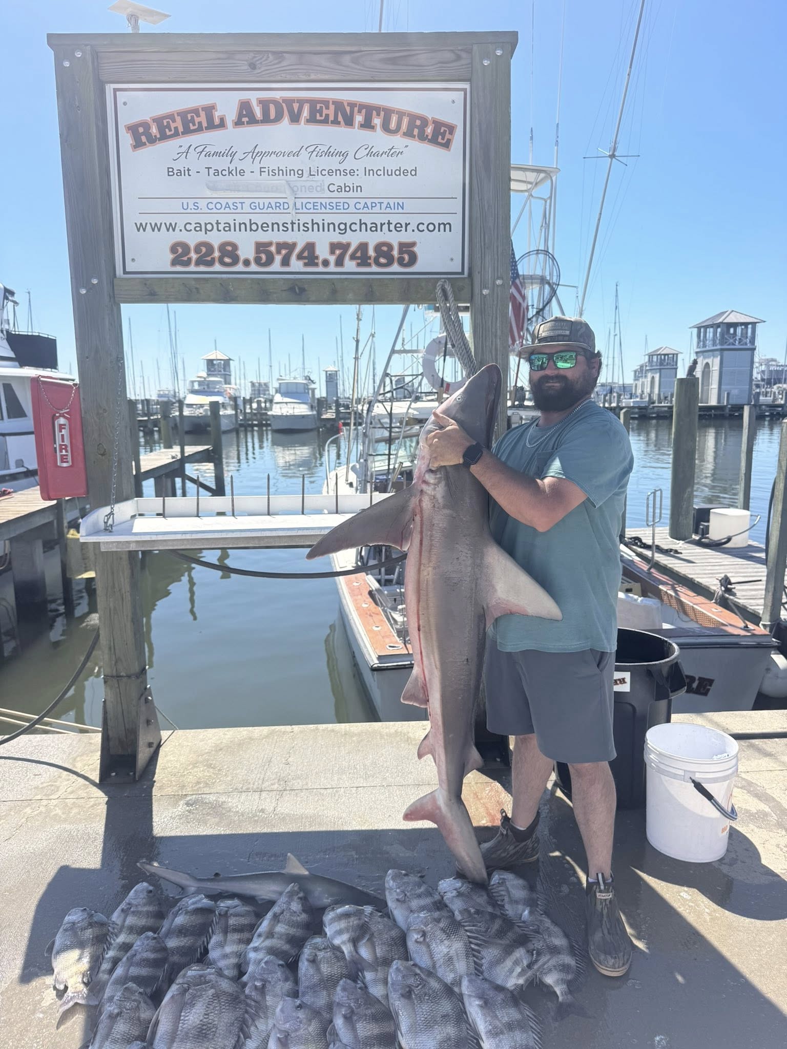 Sandbar shark fishing charter catch displayed at marina dock in Gulfport MS