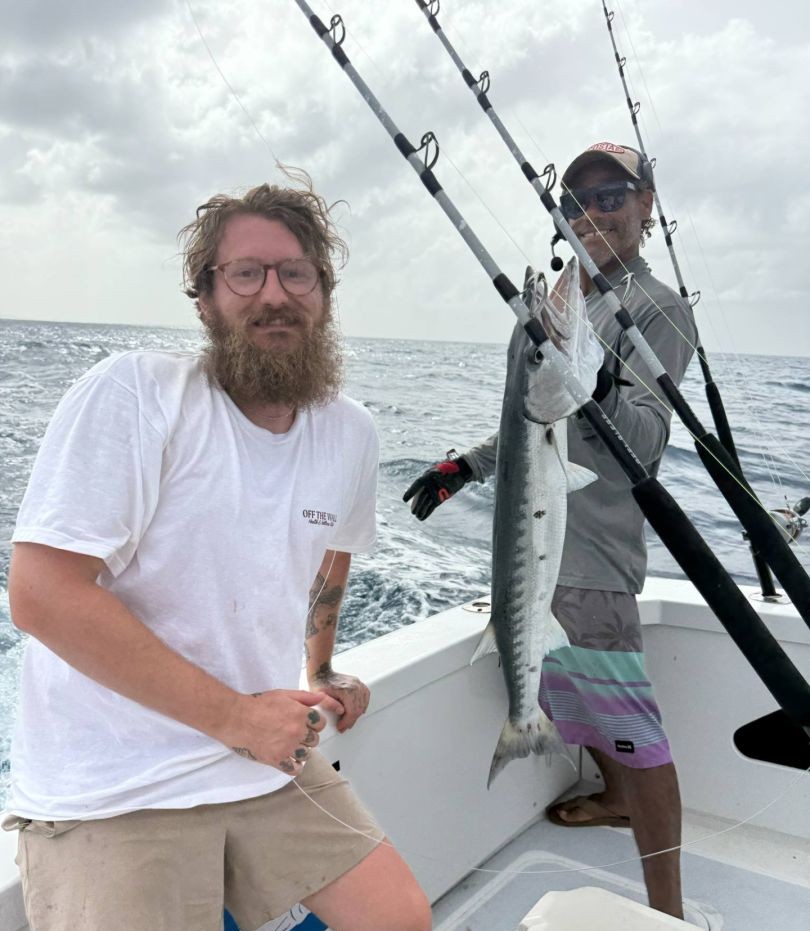 Great barracuda catch on fishing charter in San Juan PR with fishing rods visible on boat deck