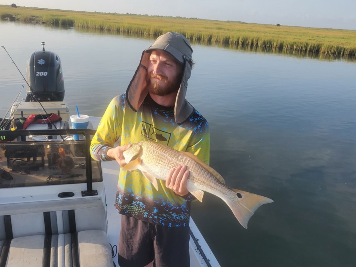 A fisherman holding a 20-inch fish in Rockport
