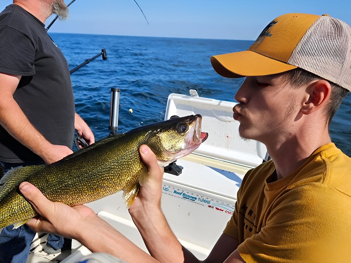 Lake Erie walleye fishing boat with anglers trolling for fish on afternoon charter trip