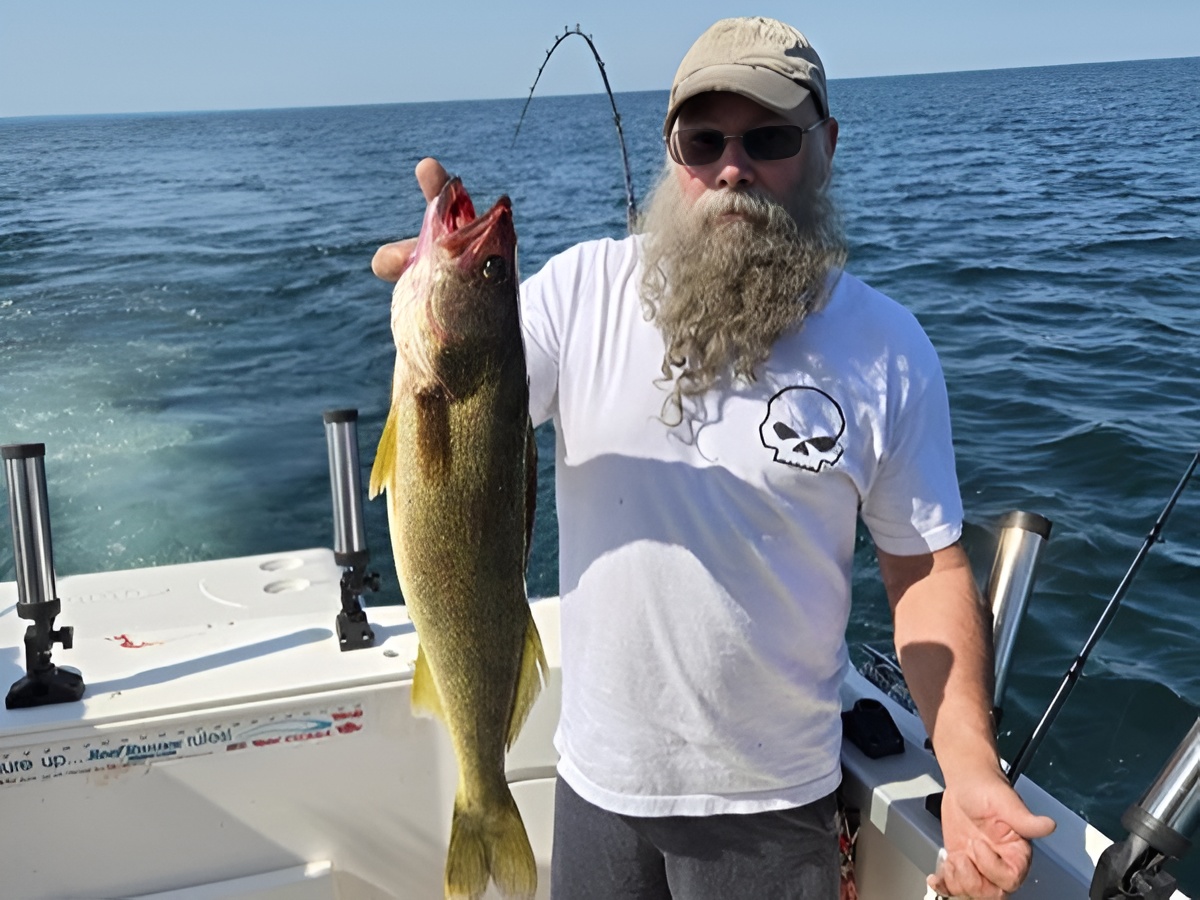 Fishing boat on Lake Erie waters with anglers trolling for walleye during morning hours