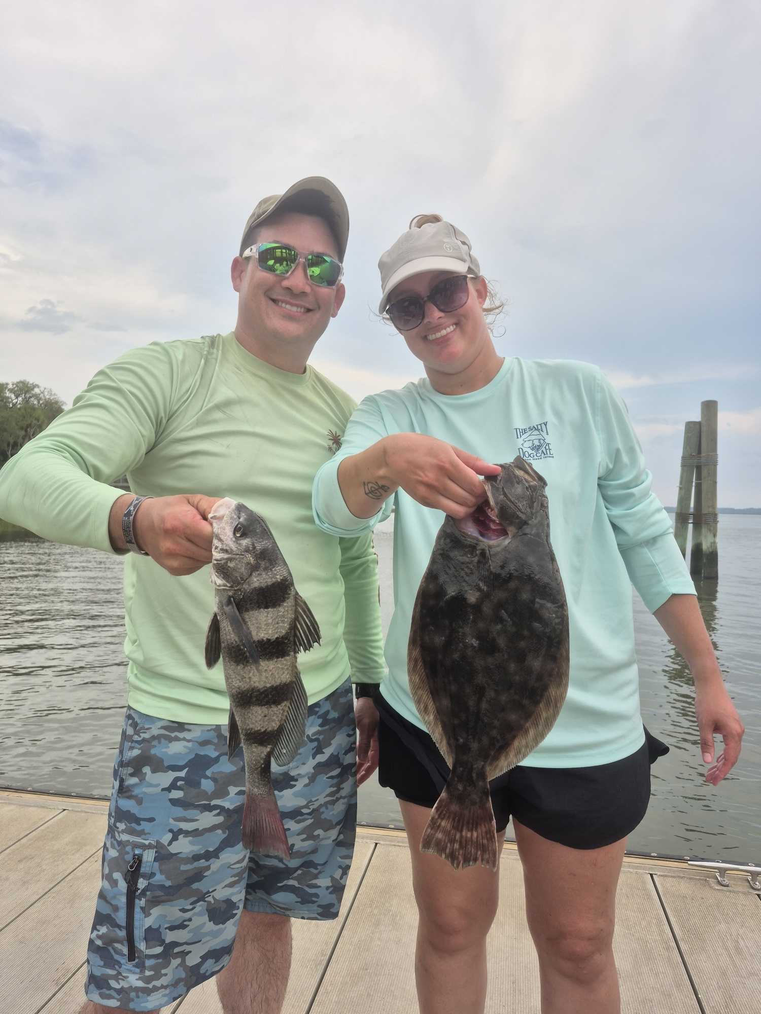 Two anglers displaying Southern Flounder and Black Drum catch on dock at Hilton Head Island SC
