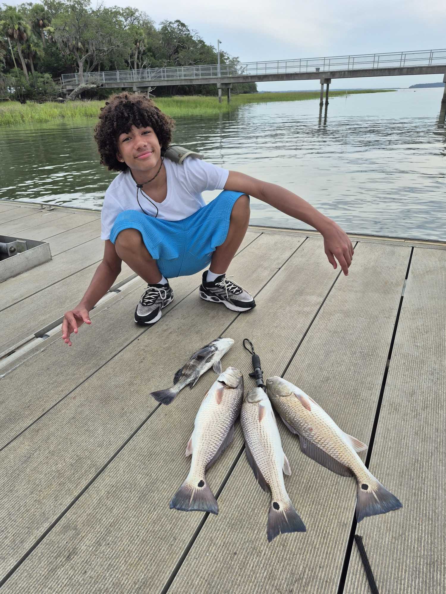 Fresh caught redfish and black drum on wooden dock at Hilton Head Island SC