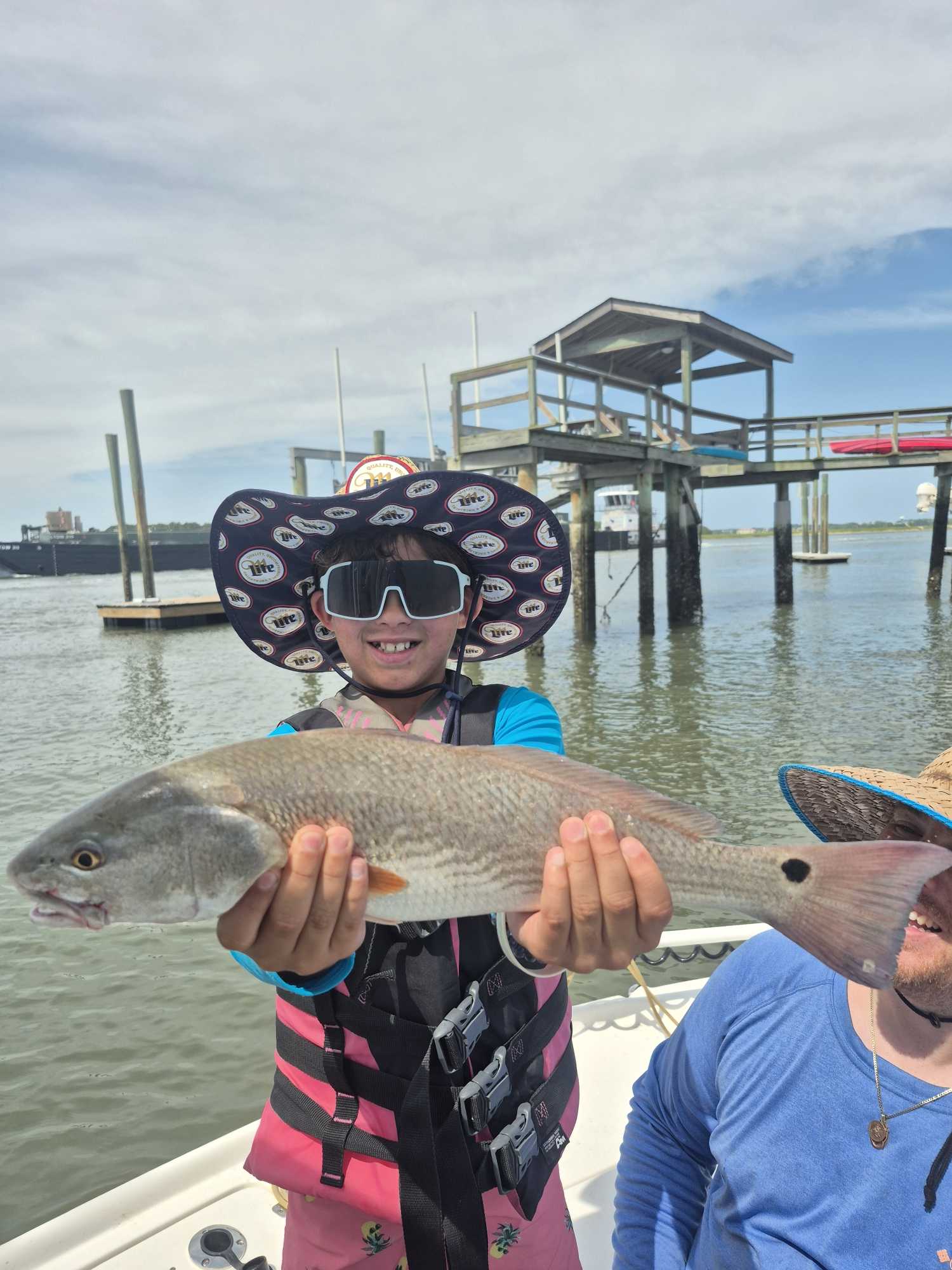 Redfish caught during fishing trip in Hilton Head Island SC waters with boat dock in background
