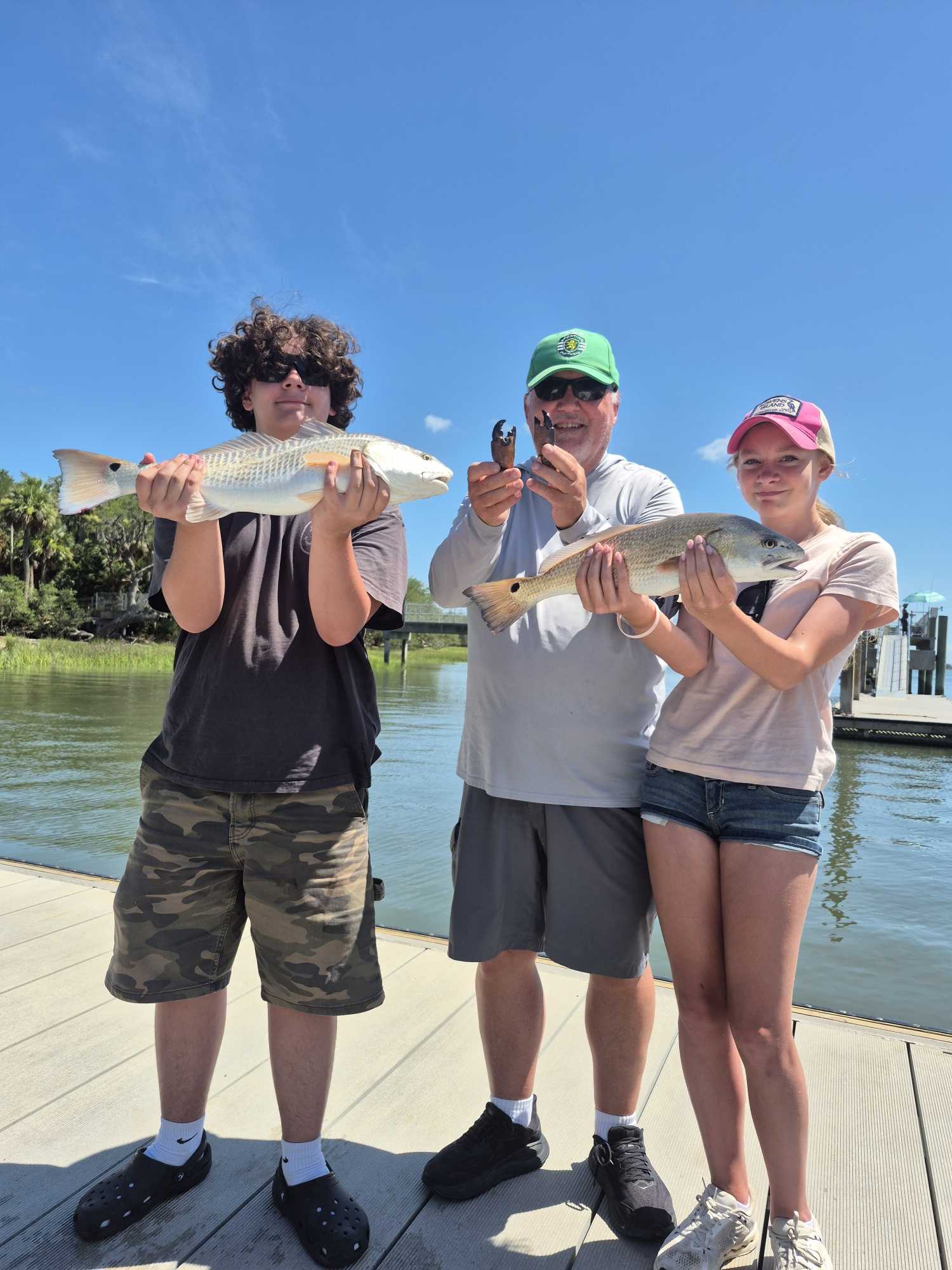 Successful redfish fishing trip on Hilton Head Island SC with fresh caught fish displayed on dock