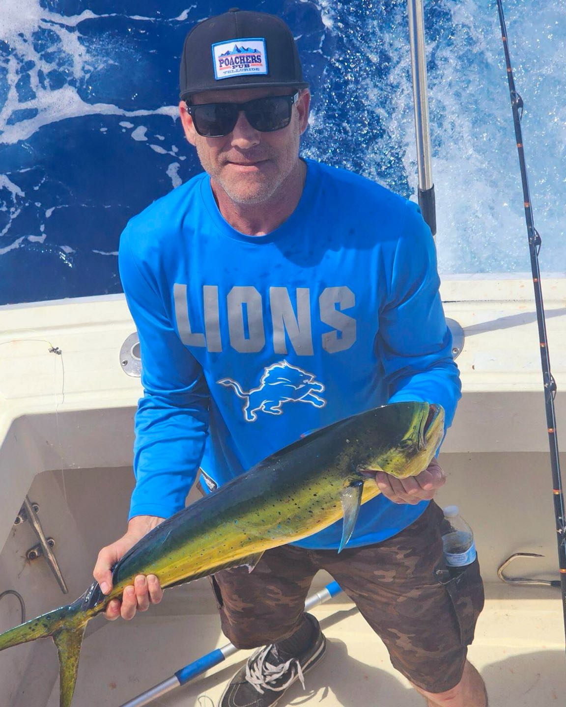 A fisherman holding a caught 18-inch fish in Sneads Ferry
