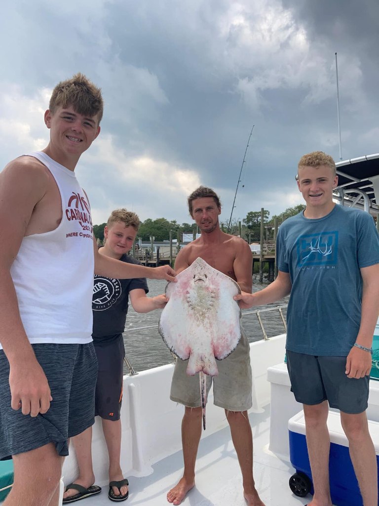 4 people enjoying a fishing trip in SC