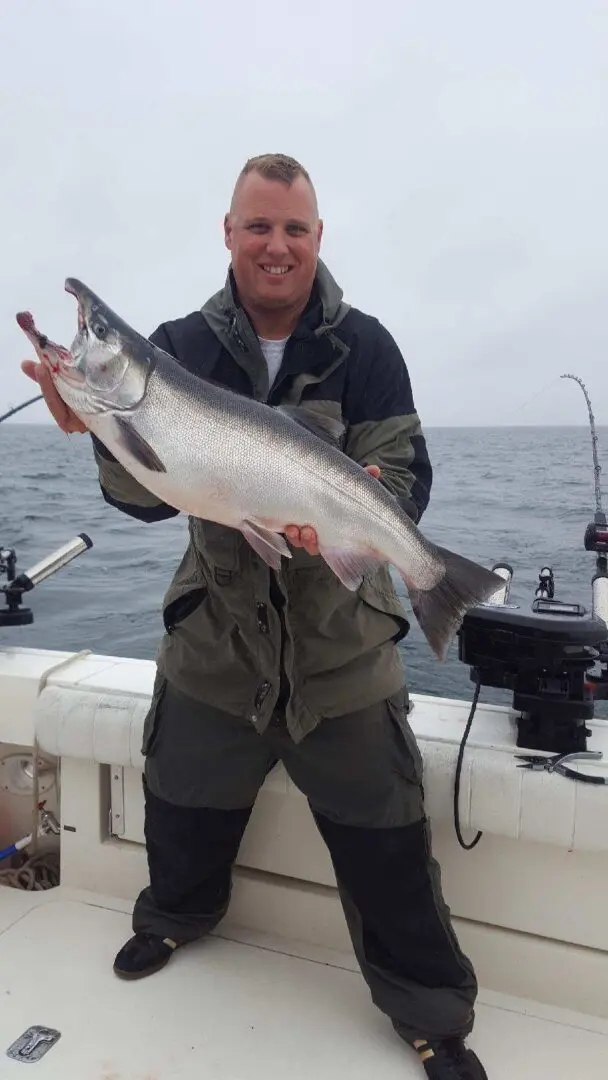 A fisherman holds a large sea trout caught in Wolcott.