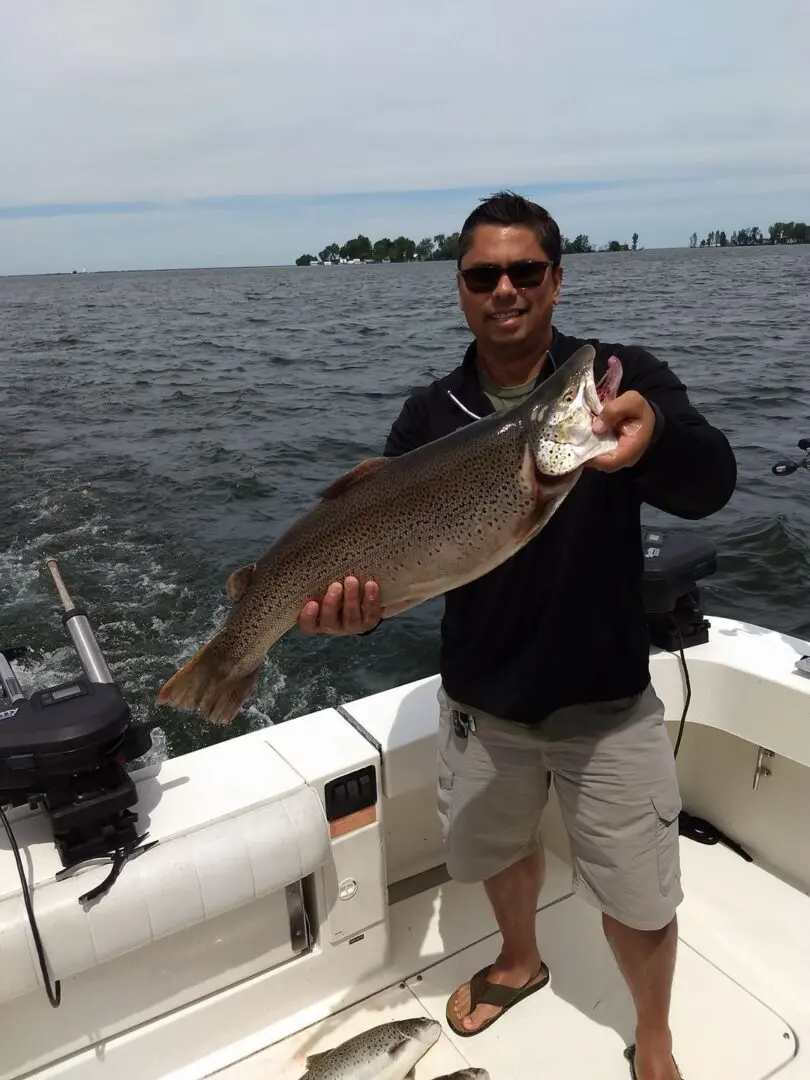 Angler holding a rainbow trout in NY