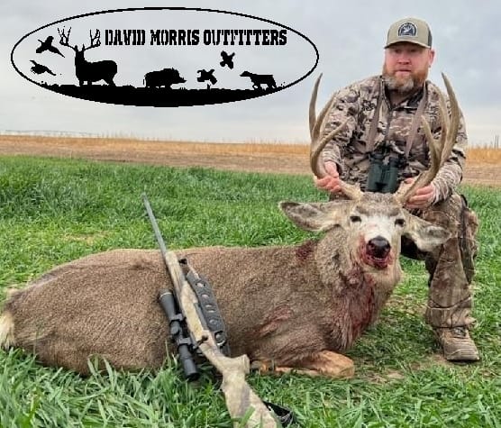 Successful deer hunt in Alba TX with harvested deer and rifle on grass field