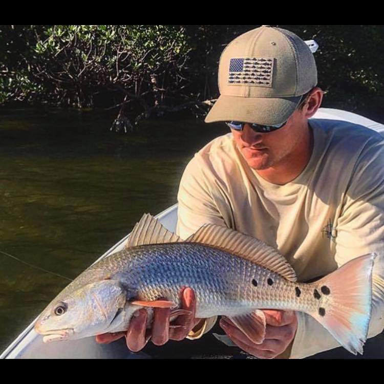 A fisherman with a large redfish catch in FL