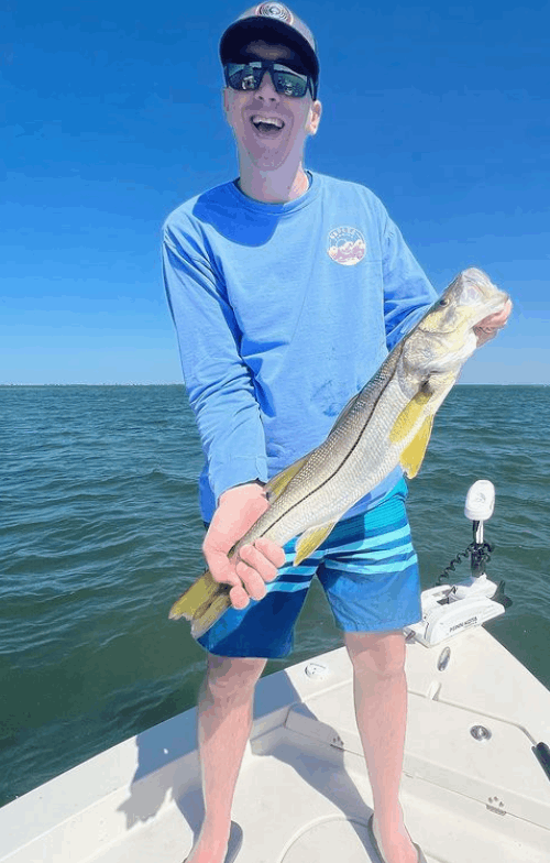 A fisherman holds a snook fish caught in FL.