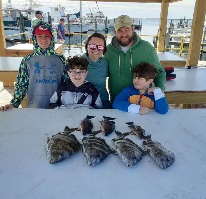 Group of 8 people fishing on the Gulf Shores beach