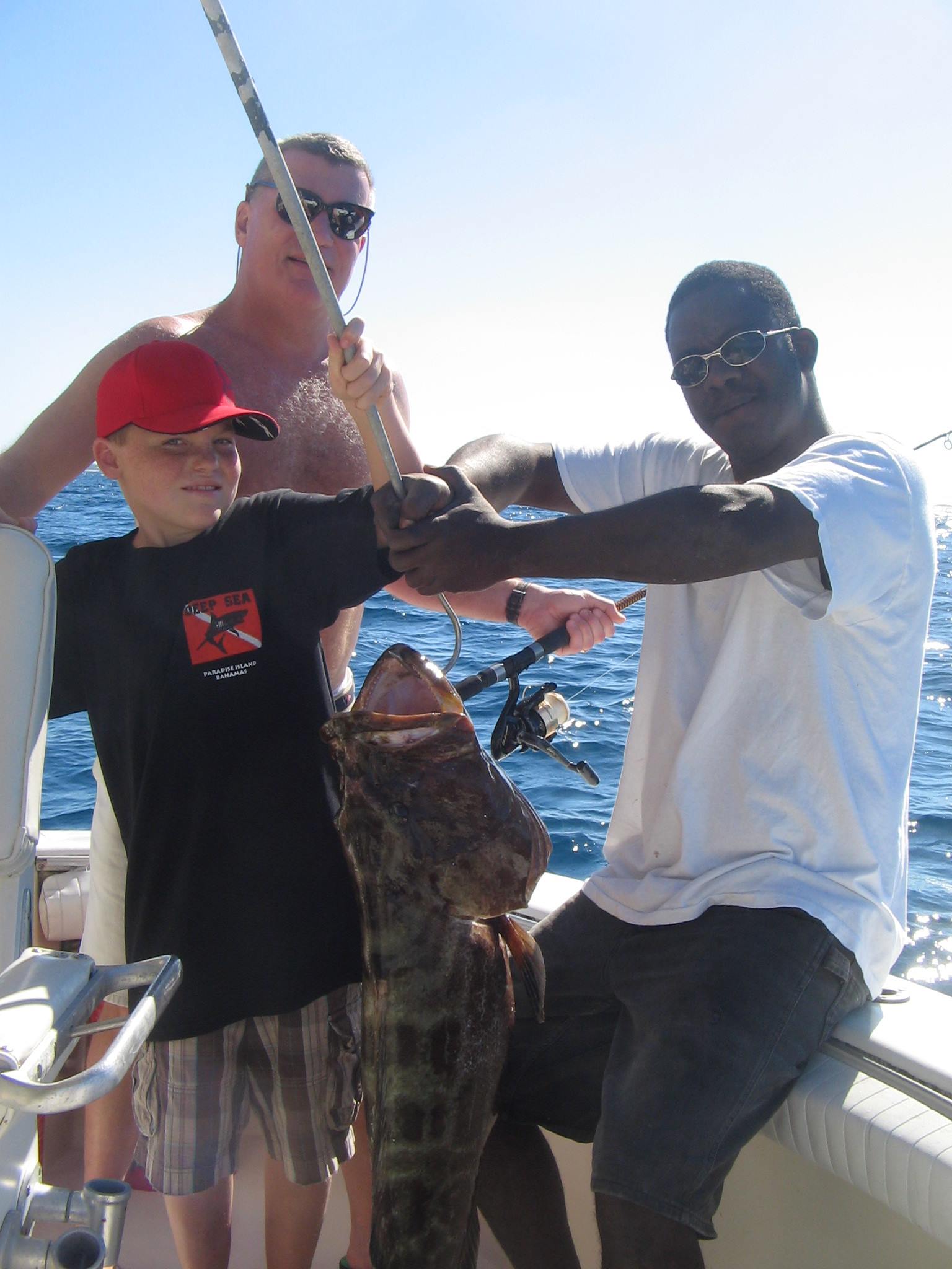 Anglers catch a large black grouper fish in Nassau