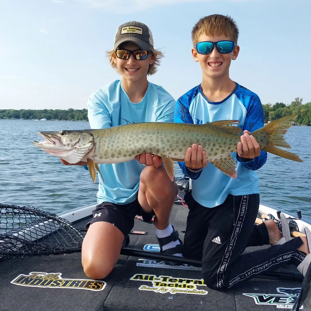 Two anglers with a big 27-inch fish on hook in Minnesota