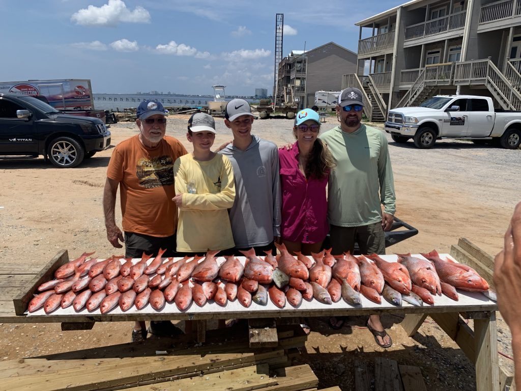 Smiling group of 5 people fishing in Florida