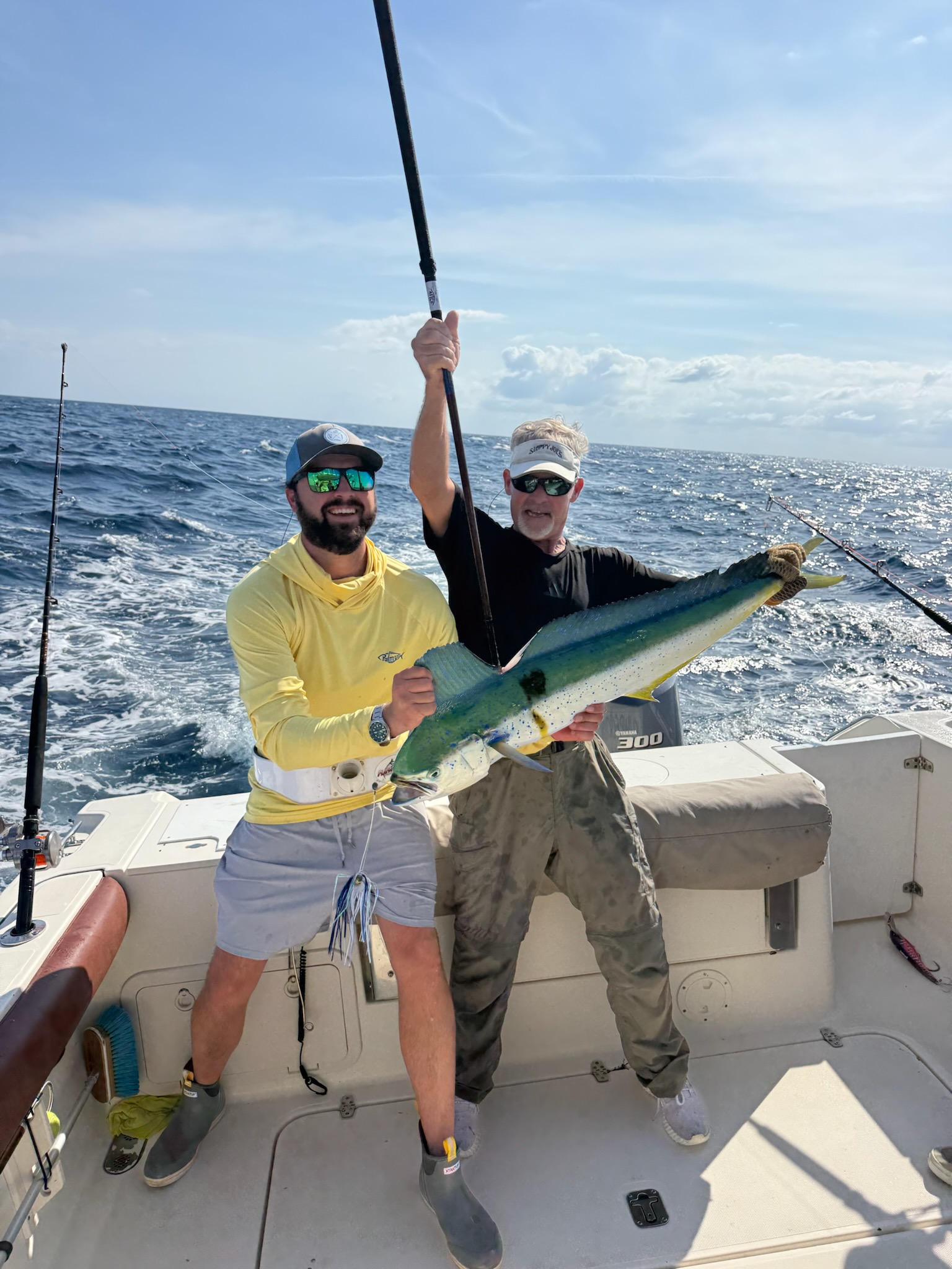 Two anglers displaying caught mahi mahi on fishing boat off Seabrook Island SC