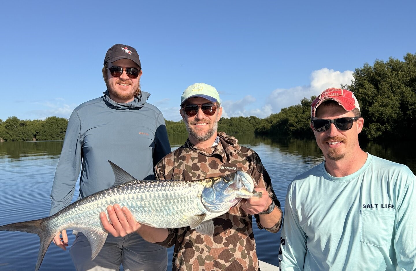 Three anglers with large tarpon fish caught in San Juan PR waters