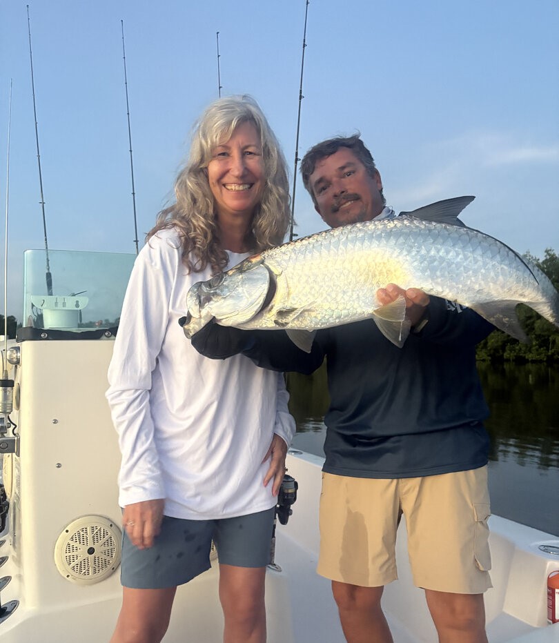 Tarpon fishing success in San Juan PR with large silver tarpon catch displayed on boat