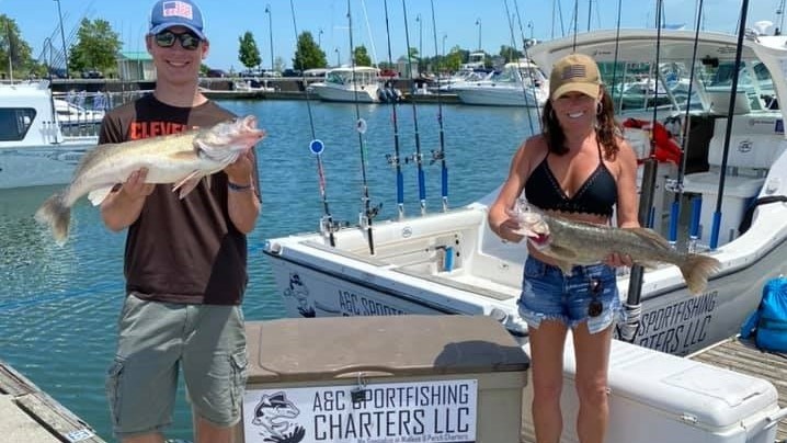 Two anglers holding large fish in Lorain