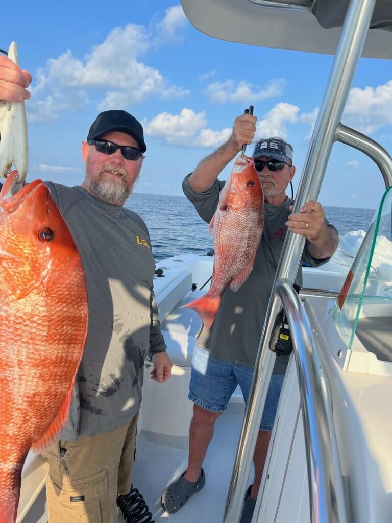 Two people fishing on Dauphin Island with 2 big fish