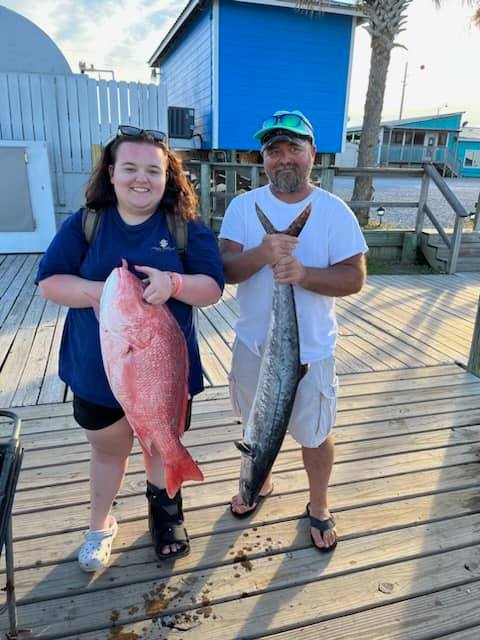 Two people fishing with two large fish on Dauphin Island