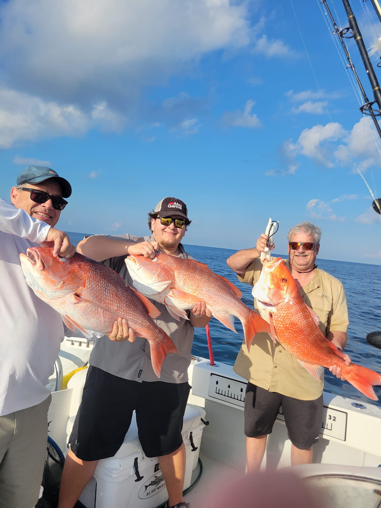 Three anglers with 3 large fish caught at Dauphin Island