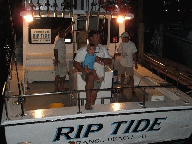 Three people enjoying a great day of fishing in Orange Beach