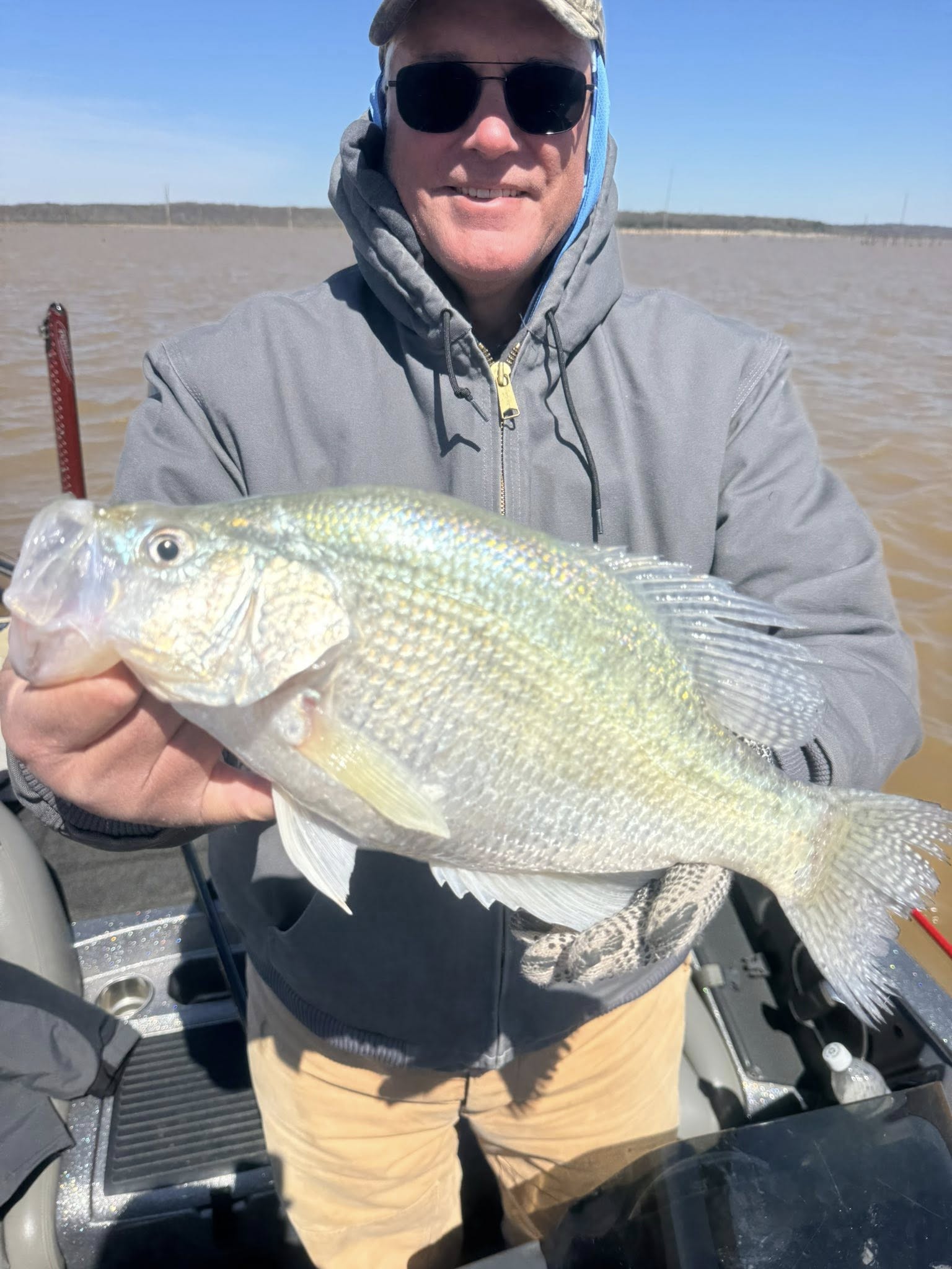 Angler holding freshly caught fish on boat in Pope MS waters