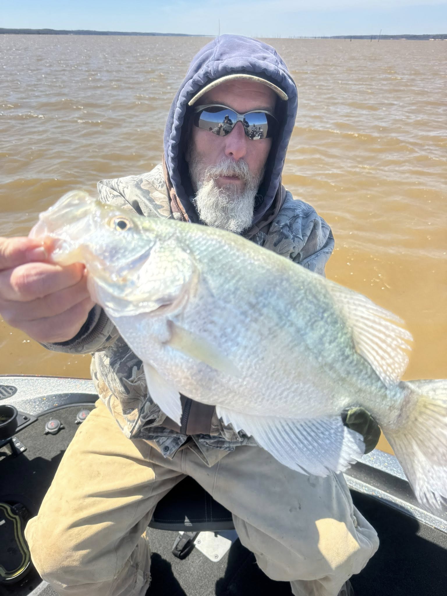 Angler holding freshly caught fish on boat in Pope MS waters