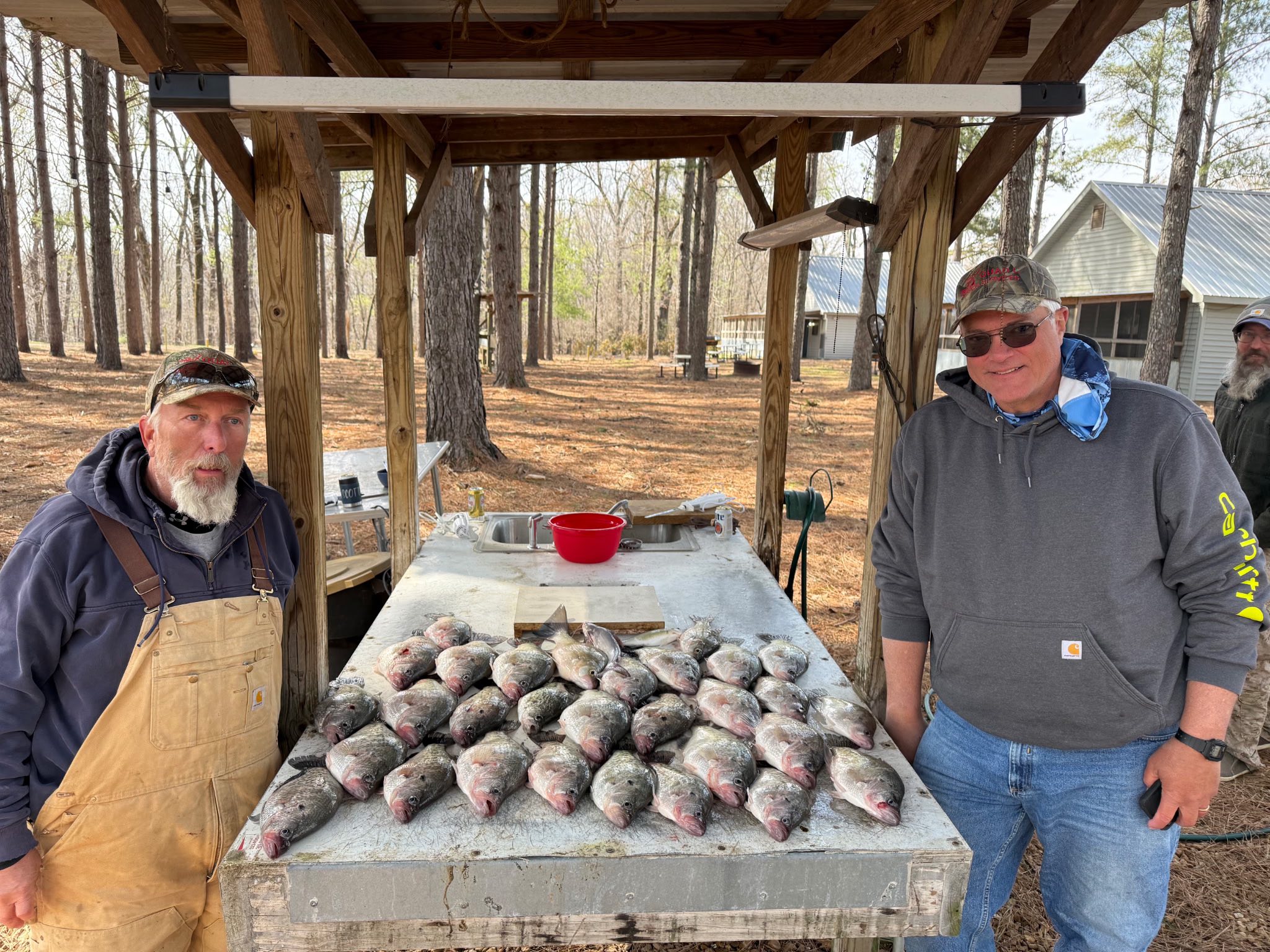 Large catch of freshly caught fish displayed on cleaning table at outdoor fish cleaning station in Pope MS