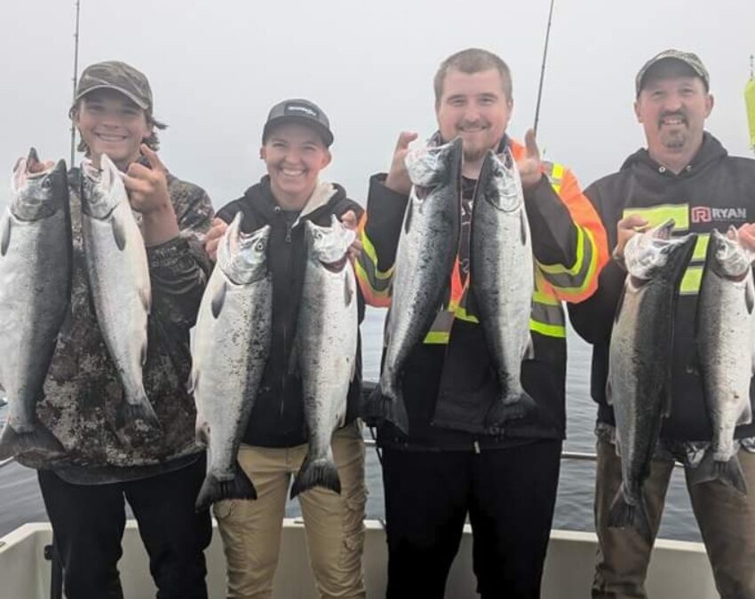 A group of 4 people fishing for rainbow trout and chinook salmon in Edmonds