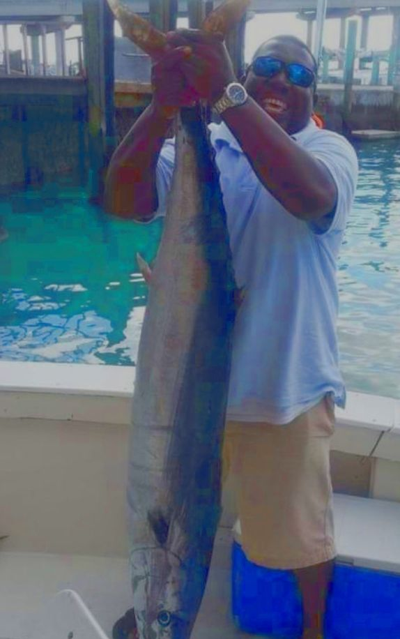 A lone fisherman in Nassau, reeling in the best catch.