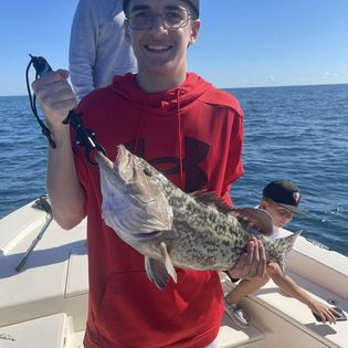 Angler with a 14-inch fish in Placida