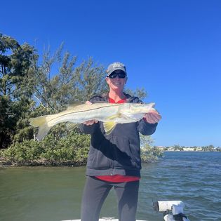 A lone fisherman reeling in a big catch in Florida