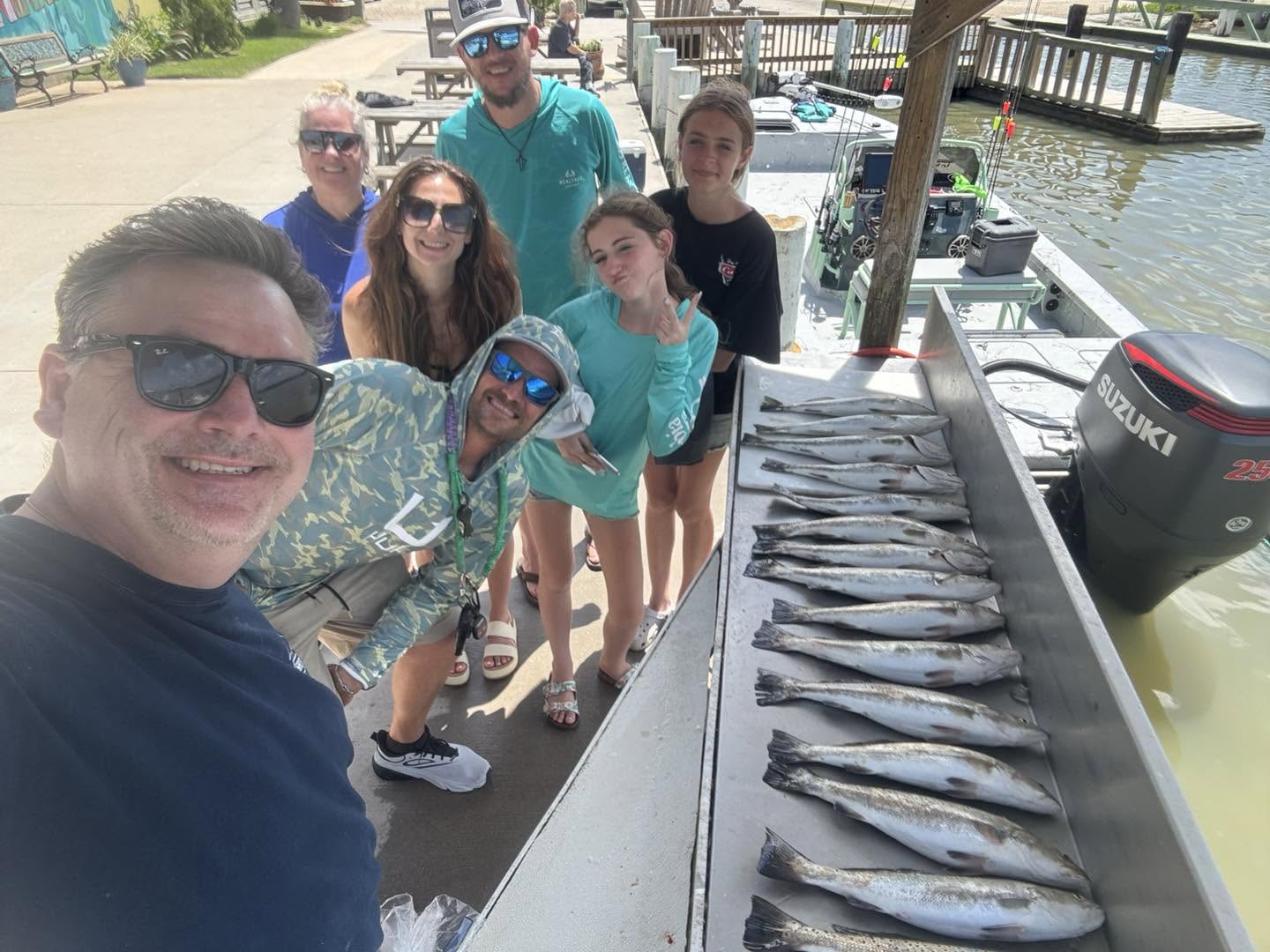 Successful fishing trip on Bolivar Peninsula TX with multiple fish species lined up on boat dock