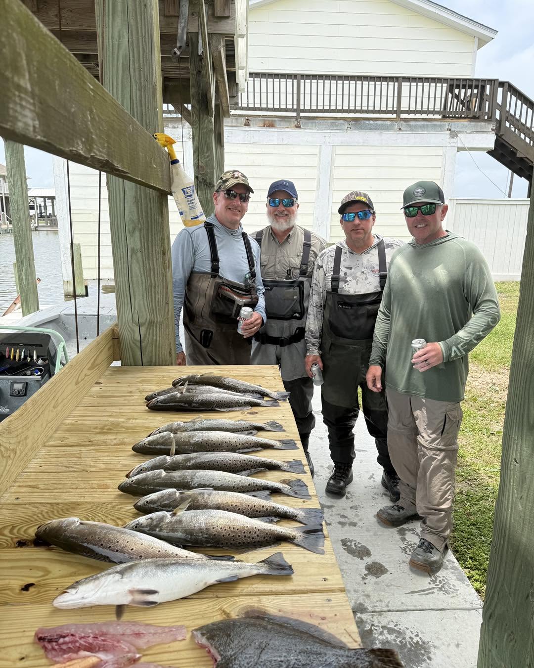 Successful speckled trout fishing trip on Bolivar Peninsula TX with multiple fish displayed on cleaning table