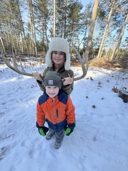 Winter outdoor scene in snowy forest area near Brownville Maine with bare trees