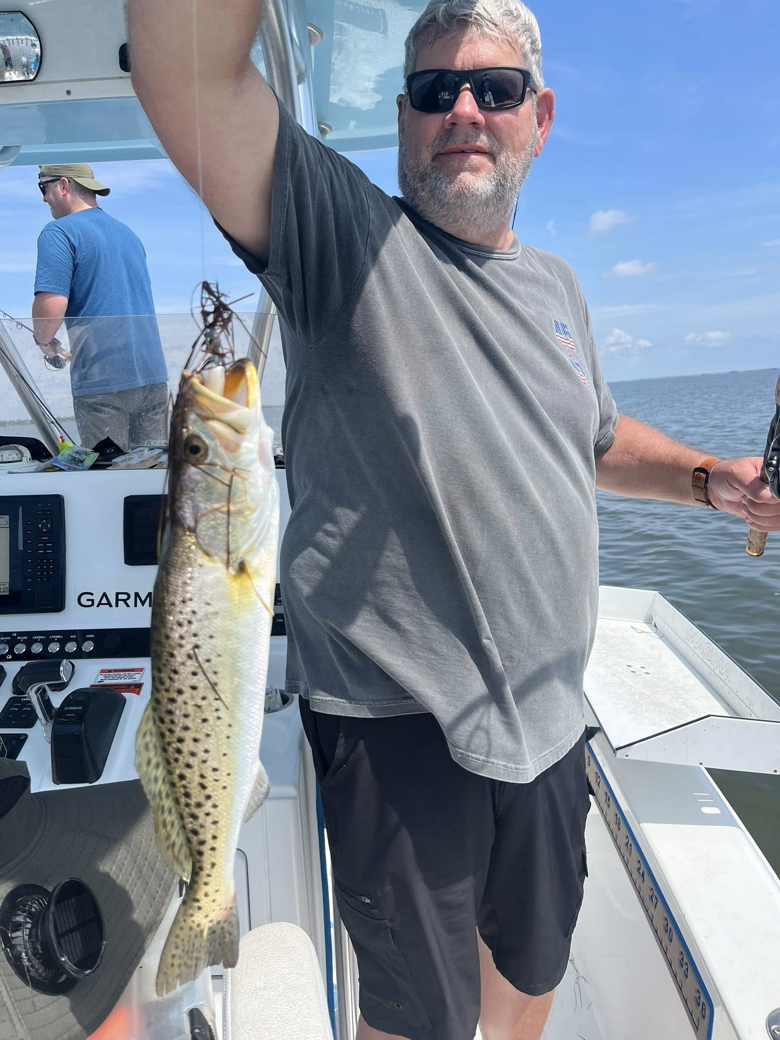 A fisherman holding a spotted weakfish in Florida