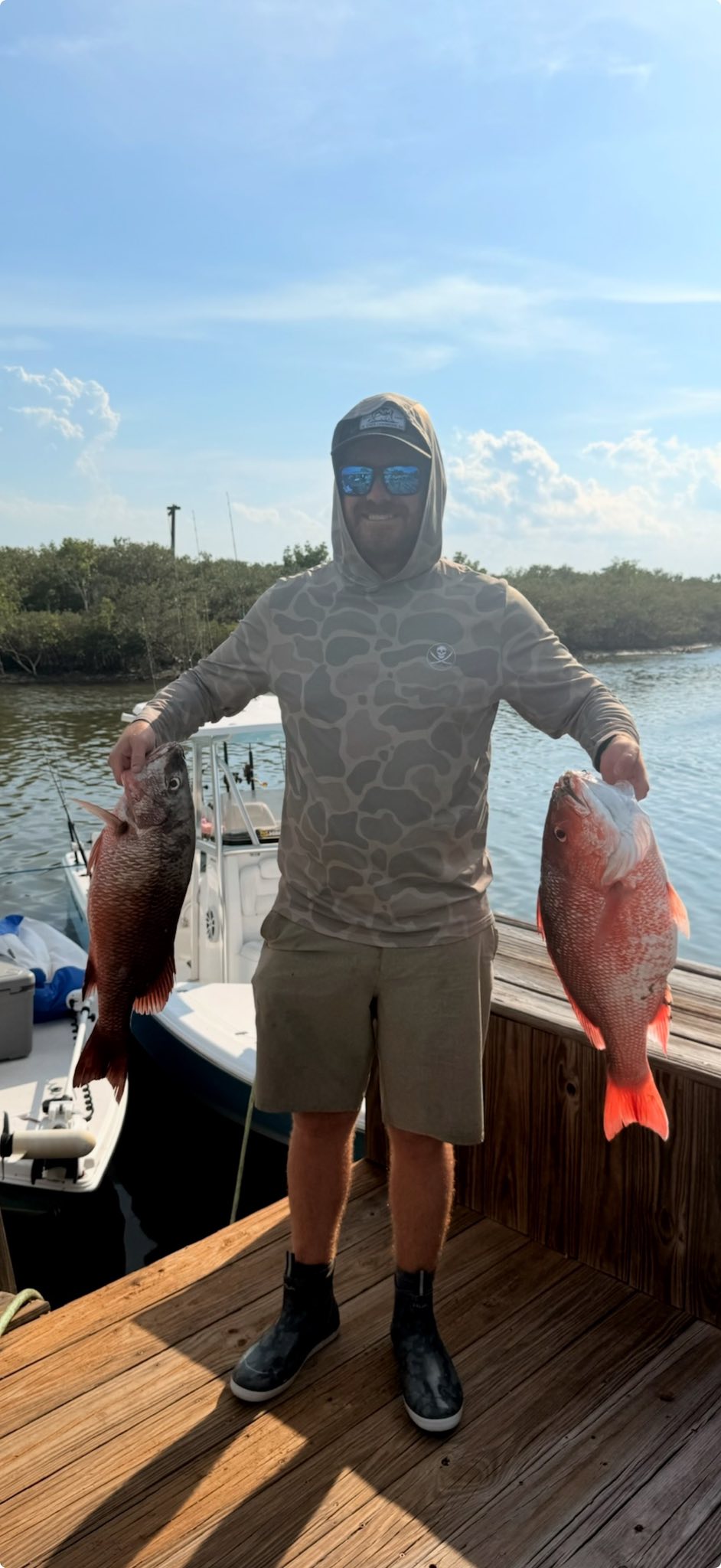 An angler holding a fishing rod while enjoying the sunny weather in FL
